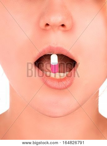 Close-up of capsule pill in woman's mouth