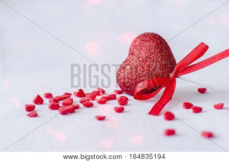 Red heart and many small hearts on the white background. Empty space for text. Valentines Day greetings card. Valentine's Day theme. Copy space.