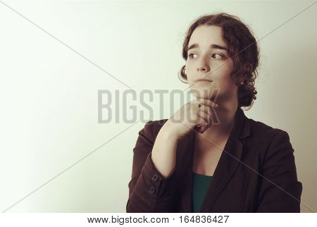 young wondering thoughtful woman looking left or right