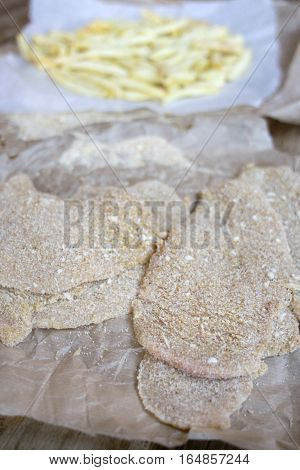 preparing breaded veal cutlet and french fries