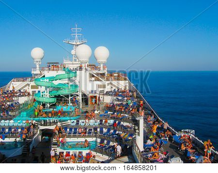 Miami United States of America - January 12 2014: The people resting at Carnival Glory Cruise Ship the ship leaving Miami USA on January 12 2014. Carnival Glory is a Conquest-class cruise ship built in 2003 with capacity of 2974 passengers