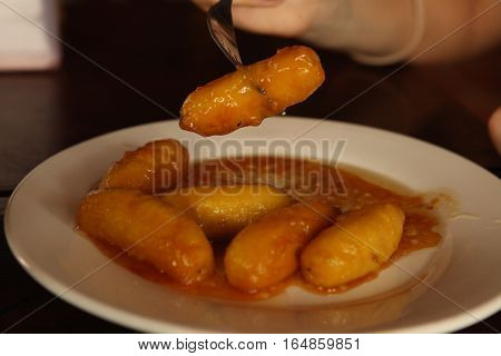 roasted mini bananas in caramel sauce close up photo