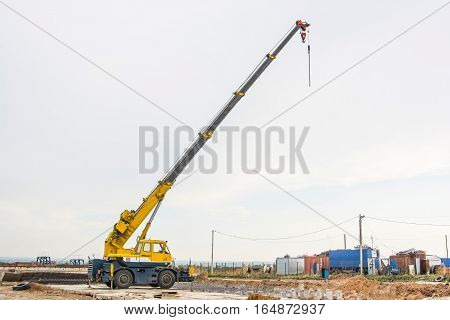 Mobile truck-mounted crane operating at construction site