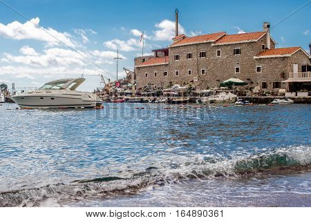 PETROVAC, MONTENEGRO - SEPTEMBER 20, 2016:The old town of Petrovac with an ancient fortress and a bay for tourist and fishing vessels, Montenegro.
