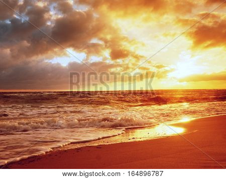 Beach Sand With Stones And Water Trails. Traces On Beach At Smooth Sea,