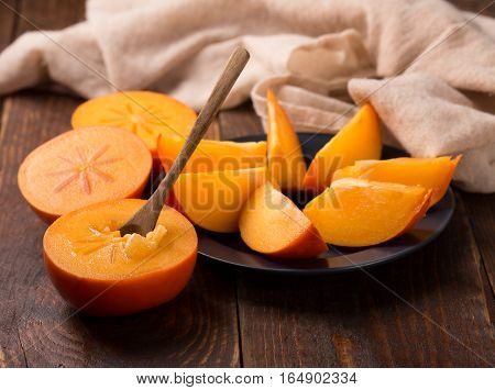 Diospyros Kaki On Rustic Wooden Background