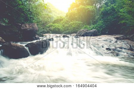 Wonderful Waterfall with rainbows in deep forest at national park Thailand.