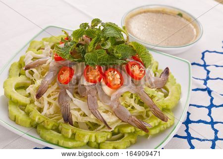 A Thai style dish of raw sea prawn served with cabbage and bitter cucumber and mint in spicy sauce.