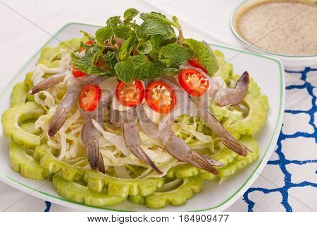 A Thai style dish of raw sea prawn served with cabbage and bitter cucumber and mint in spicy sauce.