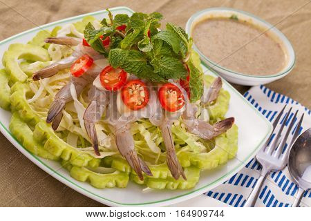 A Thai style dish of raw sea prawn served with cabbage and bitter cucumber and mint in spicy sauce.