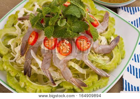 A Thai style dish of raw sea prawn served with cabbage and bitter cucumber and mint in spicy sauce.