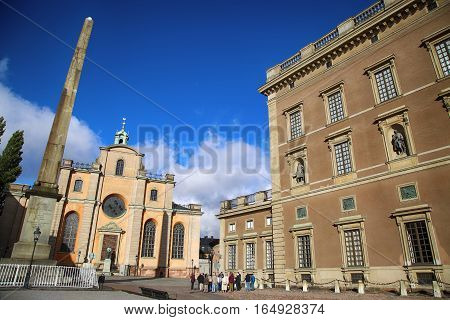 STOCKHOLM SWEDEN - AUGUST 19 2016: Church of St. Nicholas (Storkyrkan) and Obelisk located on the Slottsbacken street near the Royal Palace in Stockholm Sweden on August 19 2016.
