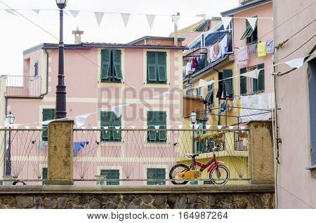Riomaggiore village La Spezia province Liguria northern Italy. View of the colourful houses on steep hills and laundry on balconies. Part of the Cinque Terre National Park and a UNESCO World Heritage Site.