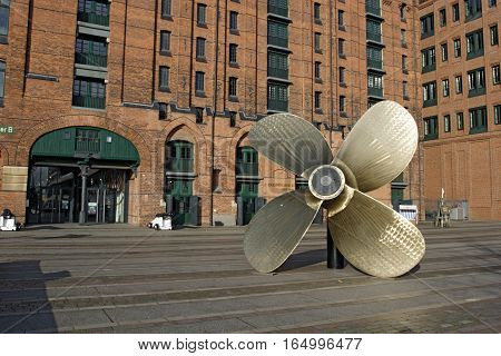 HAMBURG GERMANY - NOVEMBER 13: Big screw-propeller before The International Maritime Museum in Hamburg's Speicherstadt. Kaispeicher B building was redesigned and modernized in Hamburg Germany on November 13 2016