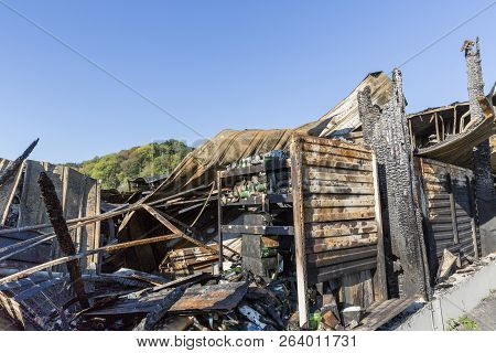 Damaged Industry Supermarket Metallic Facade After Arson Fire With Burnt Debris After Intense Burnin