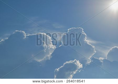 The Sun Shines Brightly In The Clear Blue Sky. Big Storm Clouds Are Coming. Cumulus Clouds Before Ra