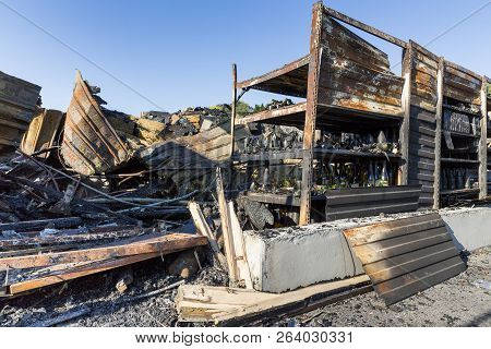 Damaged Industry Supermarket After Arson Fire With Burn Debris Of Twisted Metal Wood Structure After