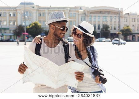 Loving African-american Couple Traveling And Reading Map, Copy Space