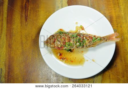 Crispy Fried Sharp Tooth Snapper Dressing With Sweet Chili Sauce On Plate