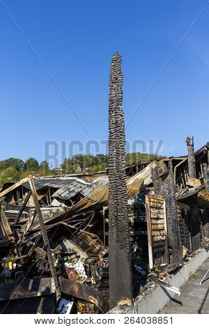 Damaged Industry Supermarket After Arson Fire With Burn Debris Of Twisted Metal Wood Structure After