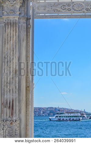 View Of The Bosphorus And White Boat Through The Gate Of The Dolmabahche Palace. Istanbul, Turkey