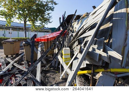 Damaged Industry Supermarket After Arson Fire With Burn Debris Of Twisted Metal Wood Structure After