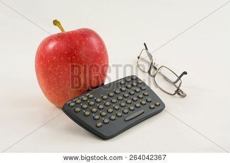 Red Apple With Mini Keyboard And Glasses On A White Background On The Table, Comic Business Still Li