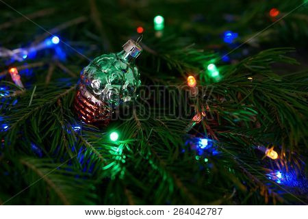 Christmas Toys - A Vintage Shiny Bump On A Tree Among The Colorful Lights. Congratulations On The Ne