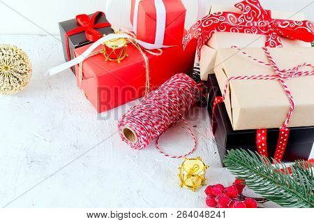 Christmas Decorative Background With Fir Branches, Cones, Redr And Black Christmas  Gifts, Ball On T
