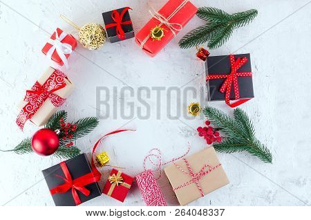 Christmas Decorative Background With Fir Branches, Cones, Redr And Black Christmas  Gifts, Ball On T