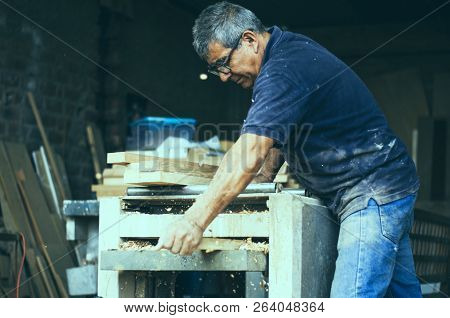 Carpenter Using Belt Sander. Carpenter Sanding A Wood