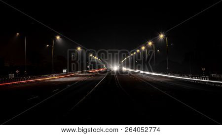 Fast Driving Vehicles Trial At Night, With Long Exposure Blurred Effect At Indian Nation Highway 19 
