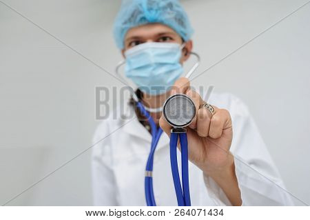 The Doctor With The Masck And Stethoscope In Hand, Close View