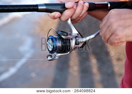 The Image Of Male Hands That Hold The Bait. The Concept Of Hobby And Recreation. Background, Cropped