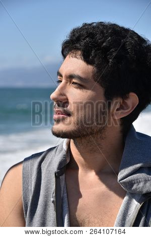 A Handsome Dark Complected Young Man Enjoying The View At The Ocean