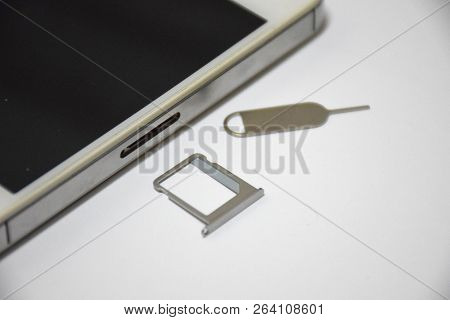 Soft Focus To Sim Card Or Subscriber Identity Module And Sim Ejector Tool From Smartphone