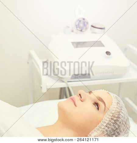 Facial Micro Current Cosmetology Procedure. Beauty Technology Treatment. Woman Face Therapy