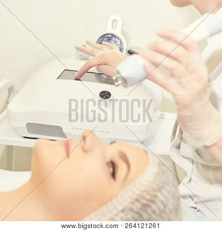 Facial Micro Current Cosmetology Procedure. Beauty Technology Treatment. Woman Face Therapy