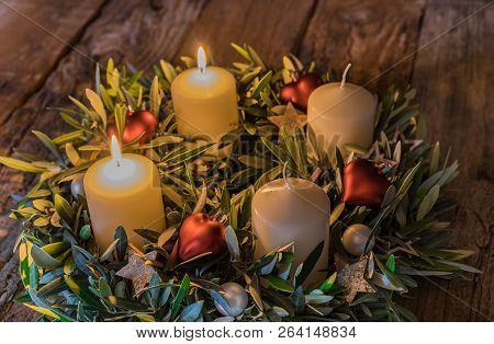 Advent Wreath Candles With Two Burning Candles And Christmas Decoration On Wooden Table, Second Adve