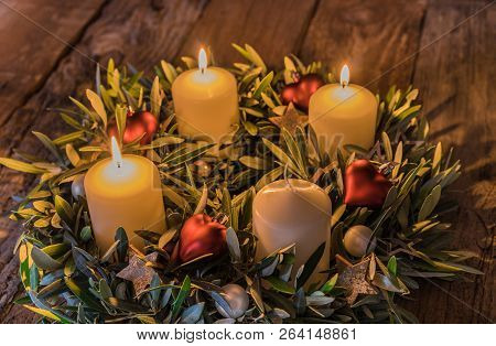 Festive Advent Wreath Candles With Three Flames And Decorations On Wood, Third Advent