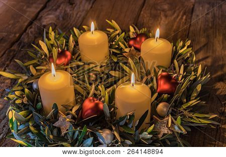 Christmas Time Tradition Symbol, Four Burning Advent Candles With Ornaments On Wooden Table, Fourth 