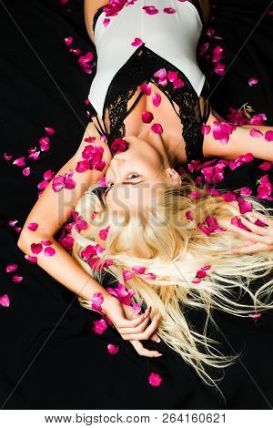 Blonde Girl With Long And Shiny Wavy Hair. Beautiful Model With Fashion Hairstyle. Trendy Haircuts