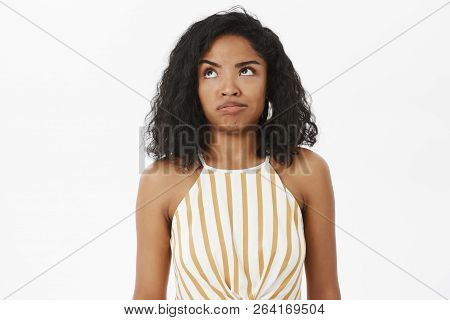 Waist-up Shot Of Clueless And Questioned Silly African American Girl Trying Understand What Made Wro