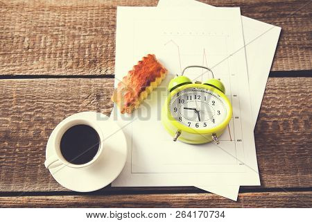Cup Of Coffee And Clock On Document Paper
