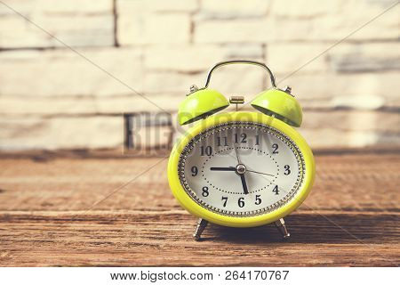 Vintage Clock On Brown Wooden Table  Background