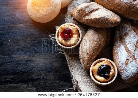 The Blueberry Pie Put Beside Baguette Berad,on Hemp Cloth,vintage And Art Tone,blurry Light Around