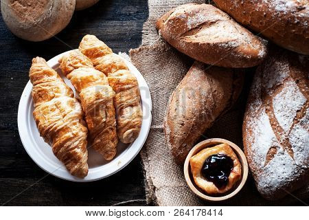 The Croissant Tray Put Beside Baguette Gread And Blueberry Pie,on Wooden Desk