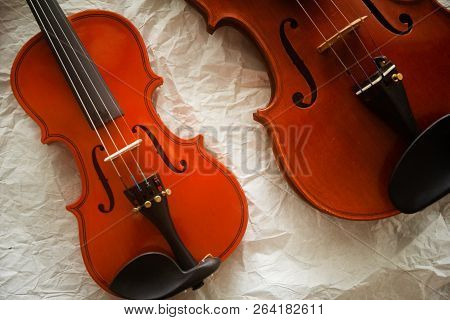 Two Different Size Of Violins Put On Background,warm Light Tone,blurry Light Adesign Background