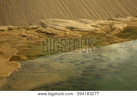 Pond With Visible Bottom, Stones In The Water And Heaps Of Sand With A Very Interesting Texture, In 