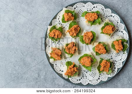 Canape With Muhammara, Adjika, Ajika Or Acuka On Small Square Breads With Round Plate.